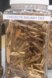 A jar of shredded railway ties displayed at a open forum by Atlantic Power.