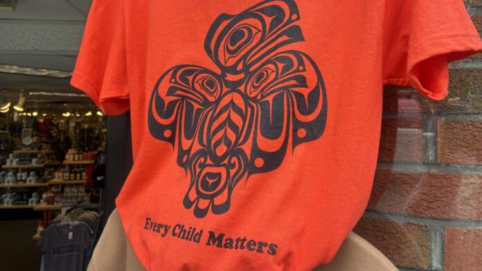 Orange shirt reading 